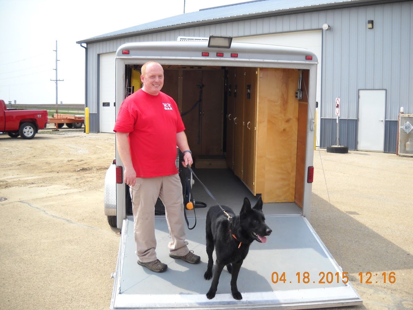 Emergency Management Representative of Search and Rescue with black dog on leash